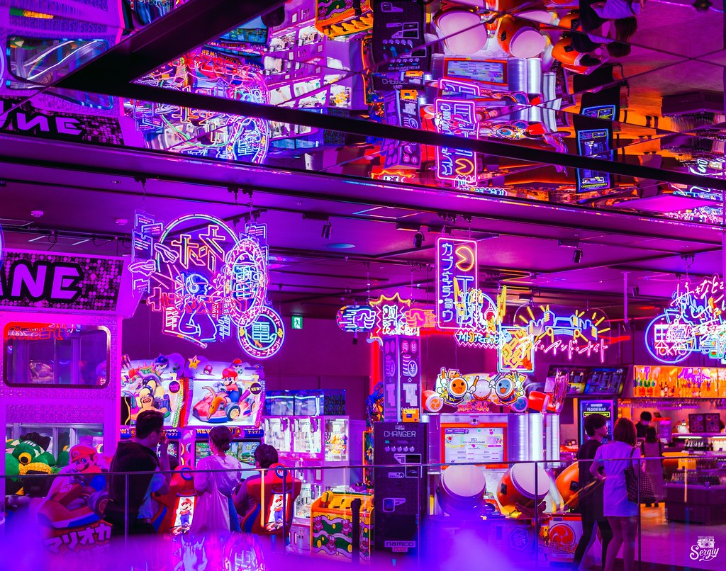Neon-lit arcade machines on an arcade floor in Tokyo